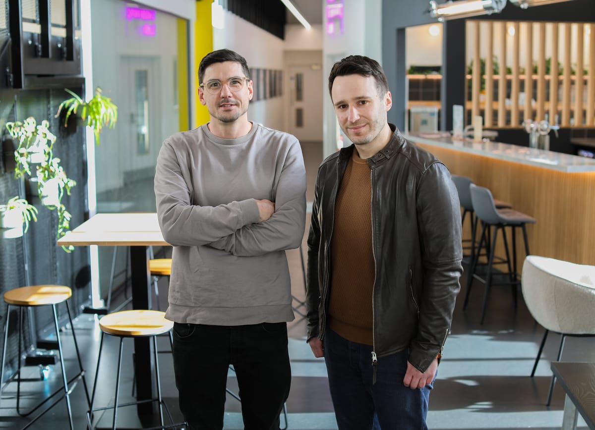 Harry Destecroix and John Williams standing in a bright, modern workspace at Science Creates.